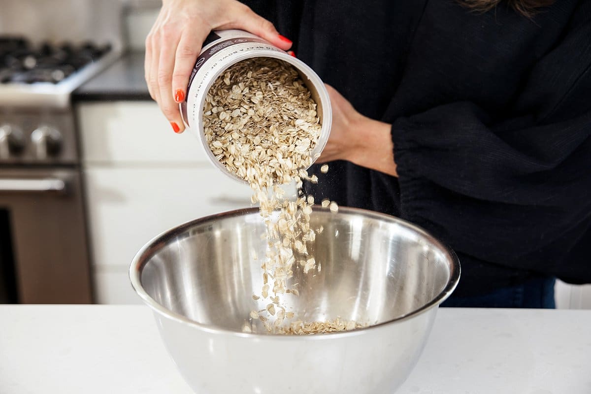 adding oats to a bowl