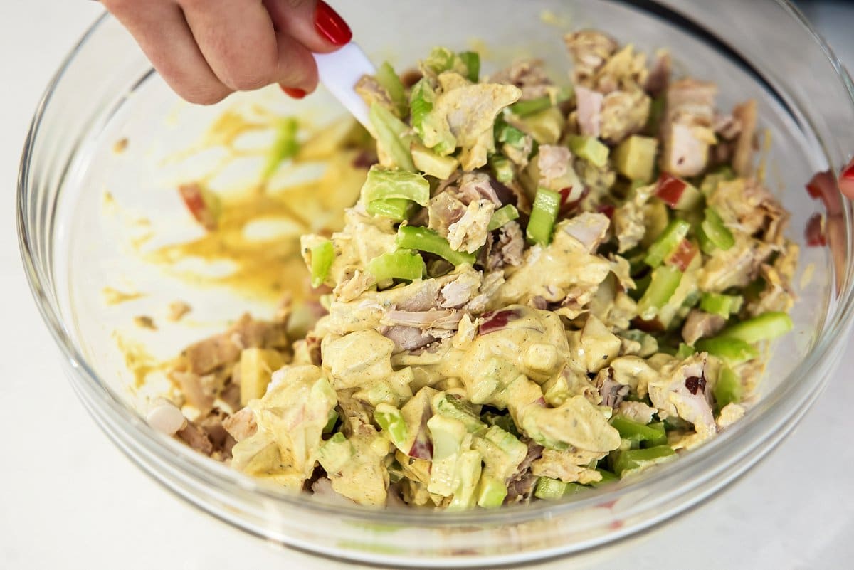 stirring curried chicken salad