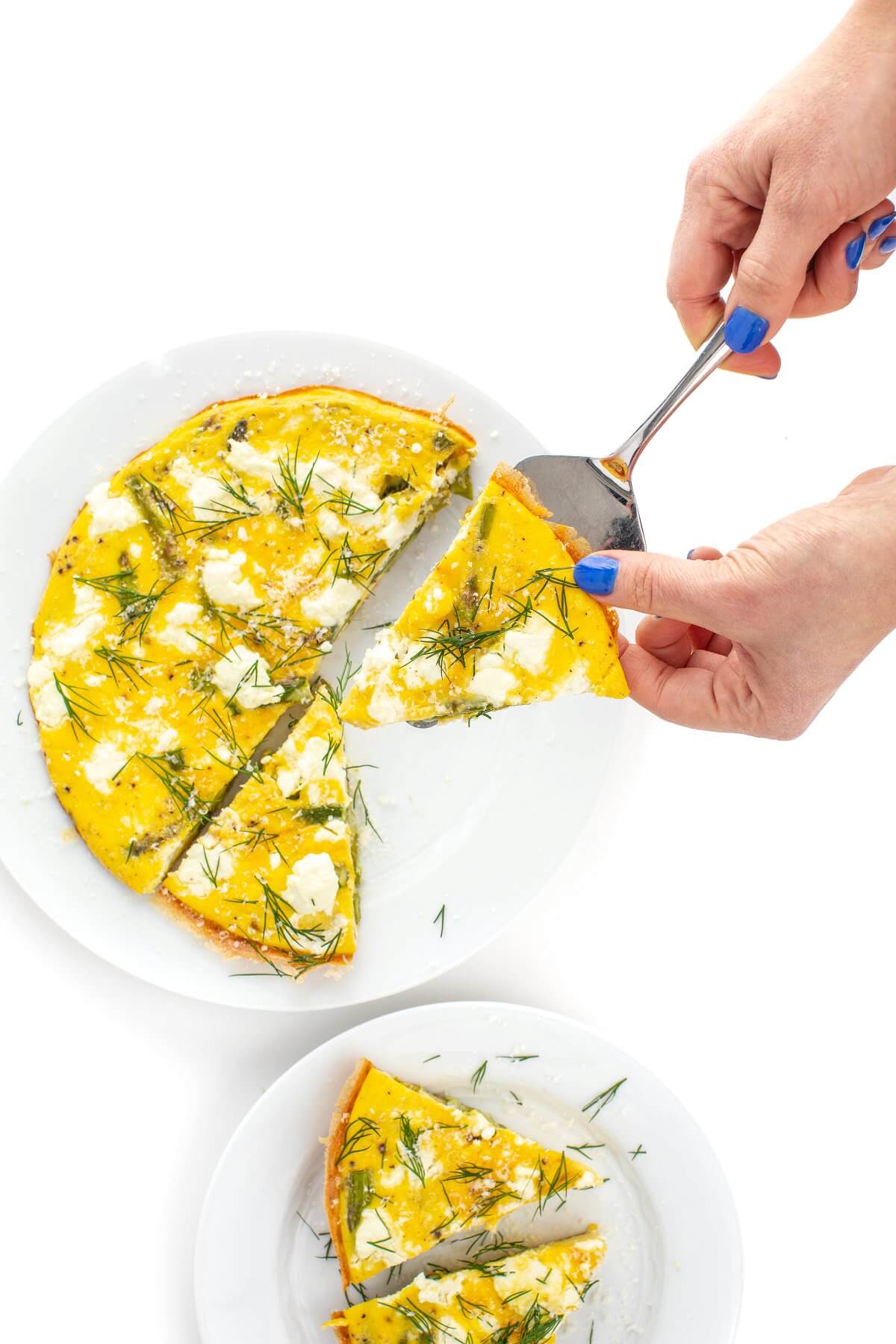 Serving an asparagus and goat cheese frittata sliced into wedges.