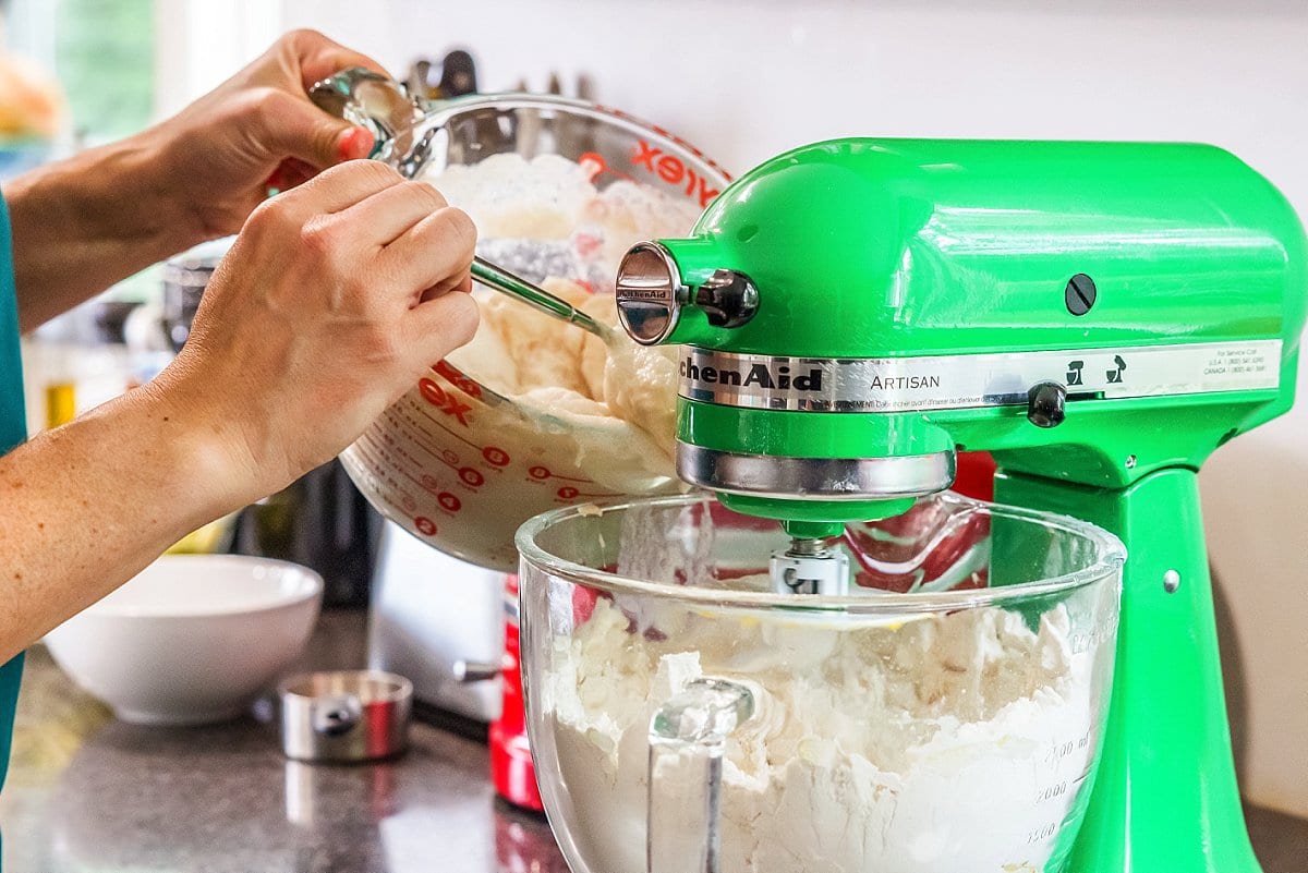 Adding Yeast and Sugar to dough in stand mixer.