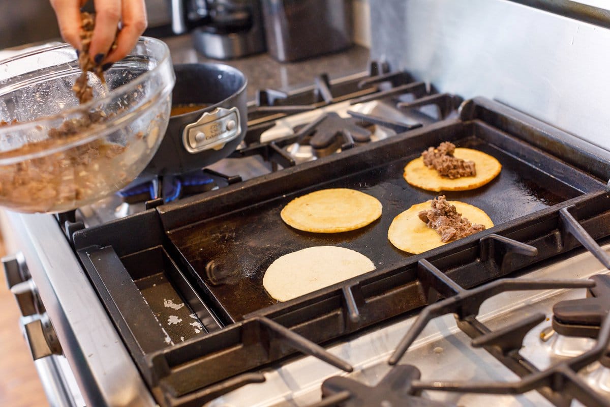 tortillas being filled with beef
