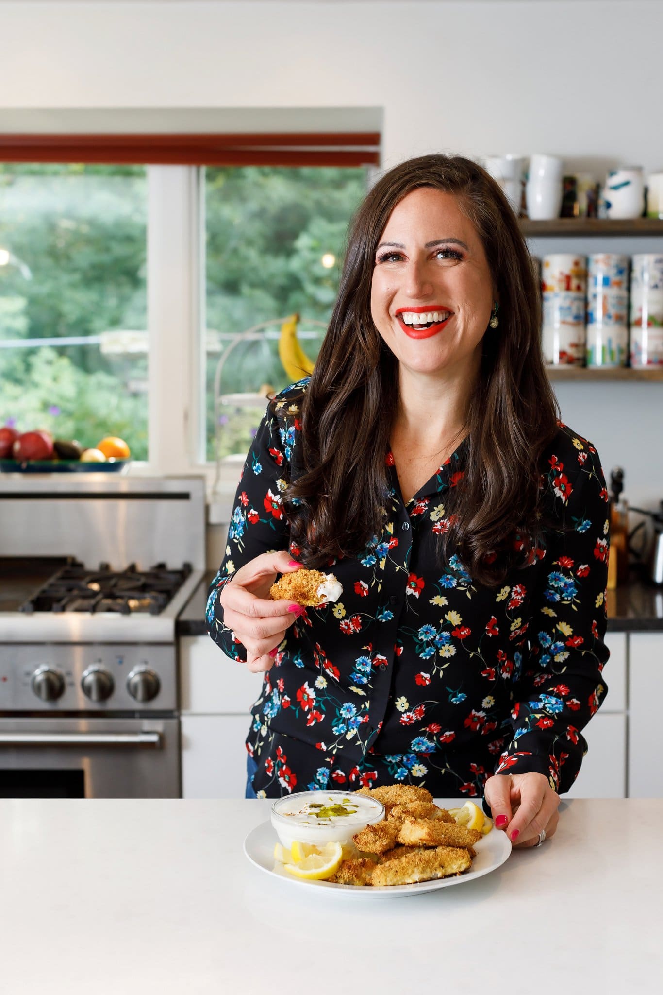 Liz eating baked fish sticks with tartar sauce.