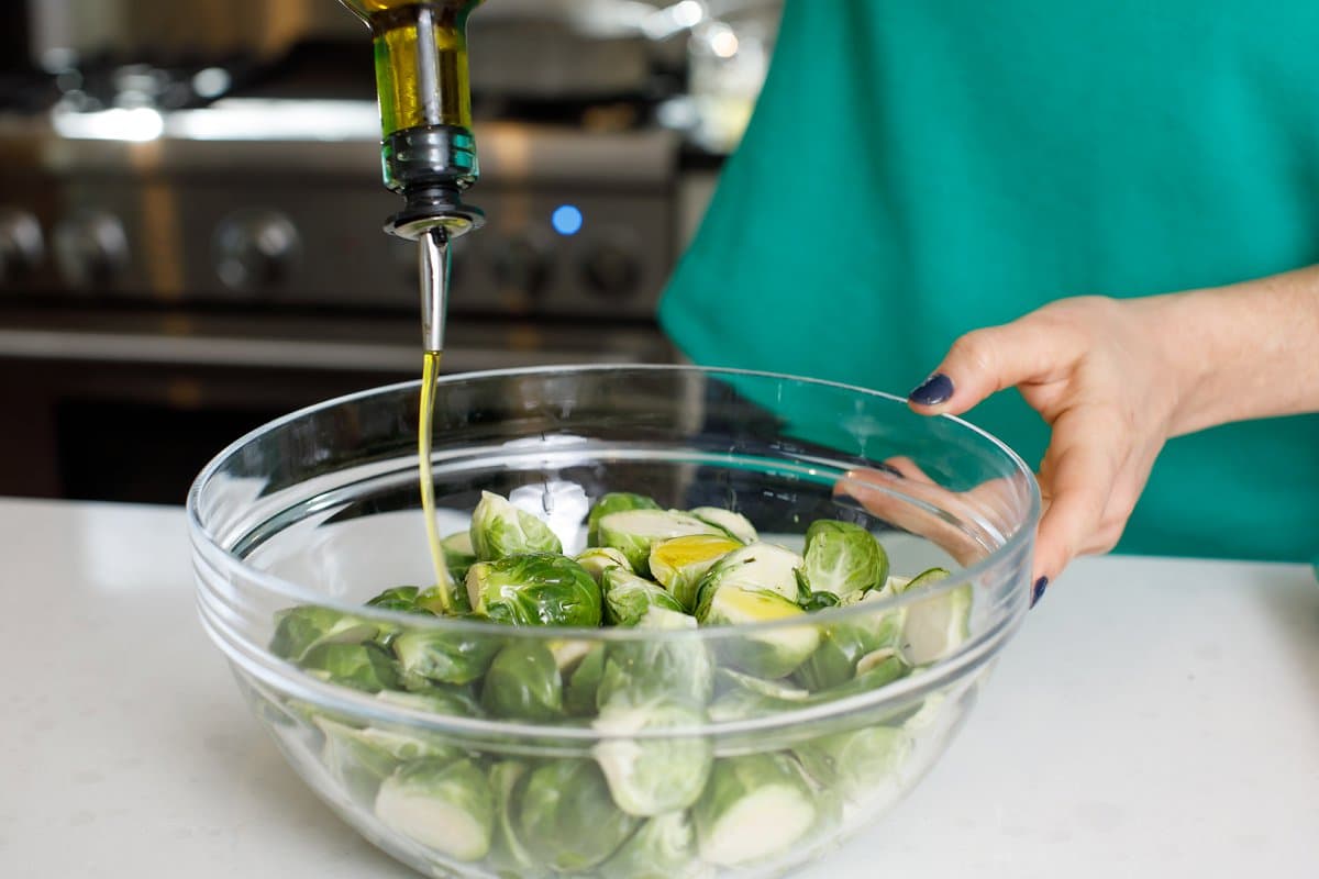 OIl being added to Brussels sprouts