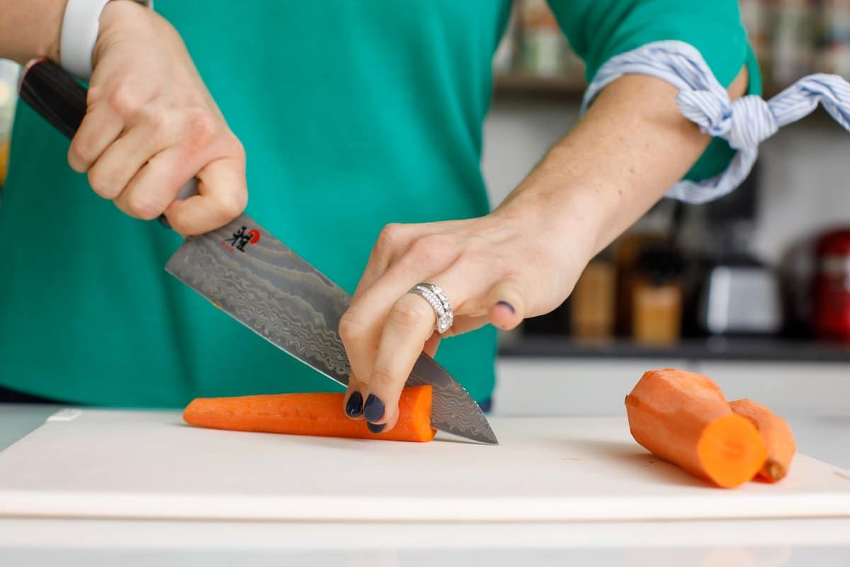 Woman slicing carrot