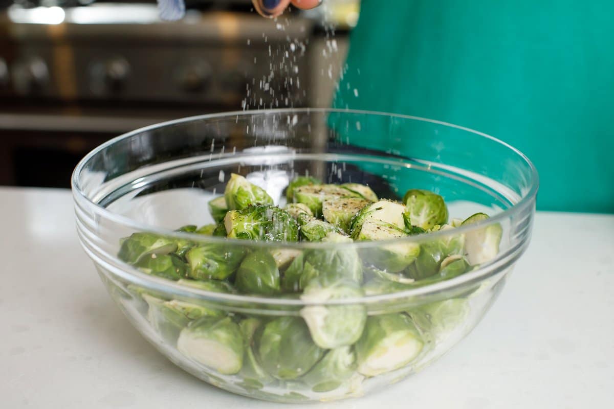 Brussels sprouts being seasoned