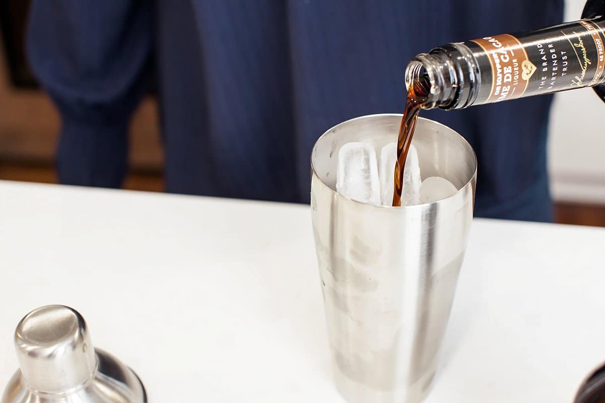 Liz pouring chocolate liqueur into a chocolate martini