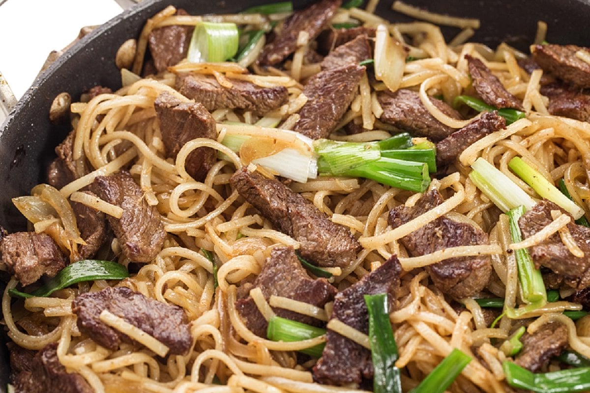 Beef Stir Fry with rice noodles and scallions.