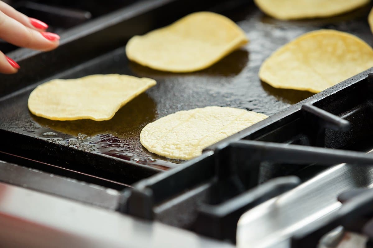 making corn tortillas on a griddle