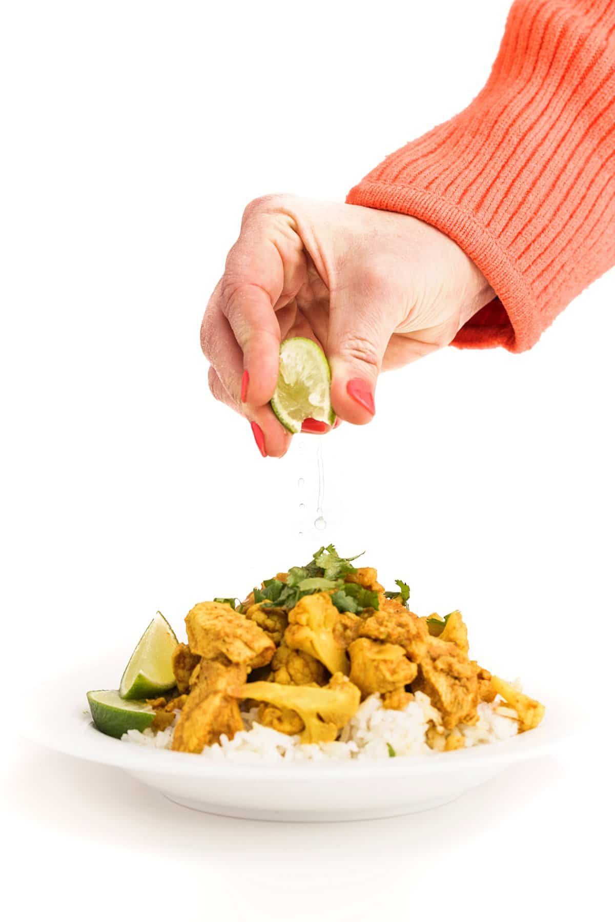 Liz squeezing lime on indian butter chicken