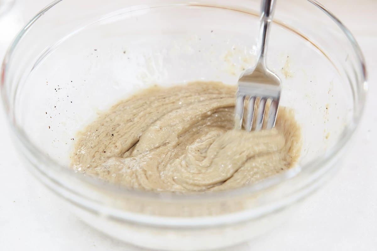 mixing tahini lemon sauce