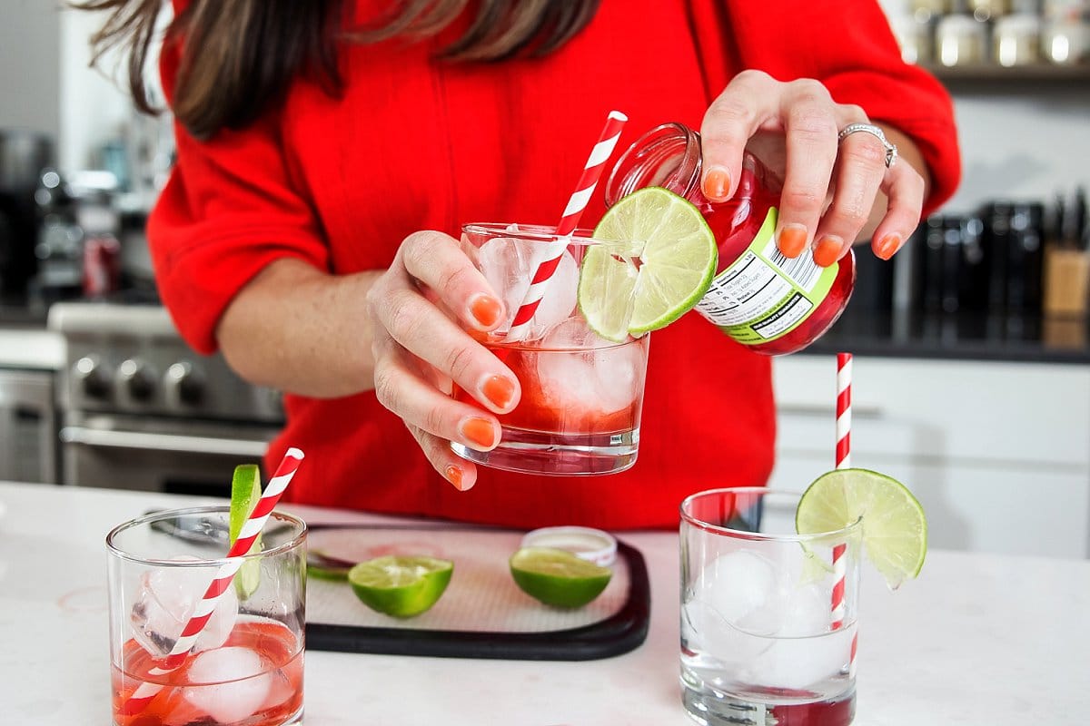 adding cherry juice to glasses