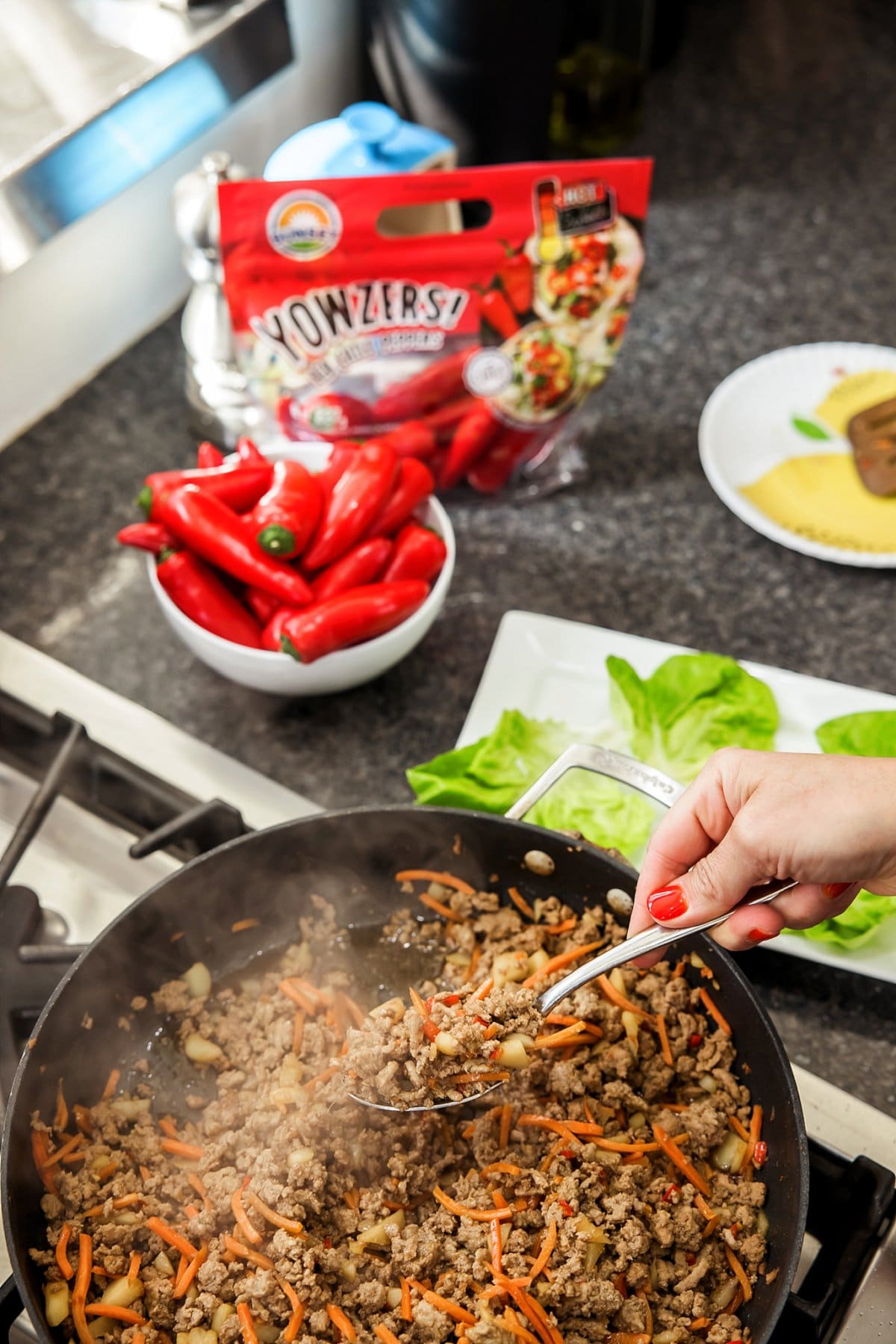 adding turkey filling to lettuce cups