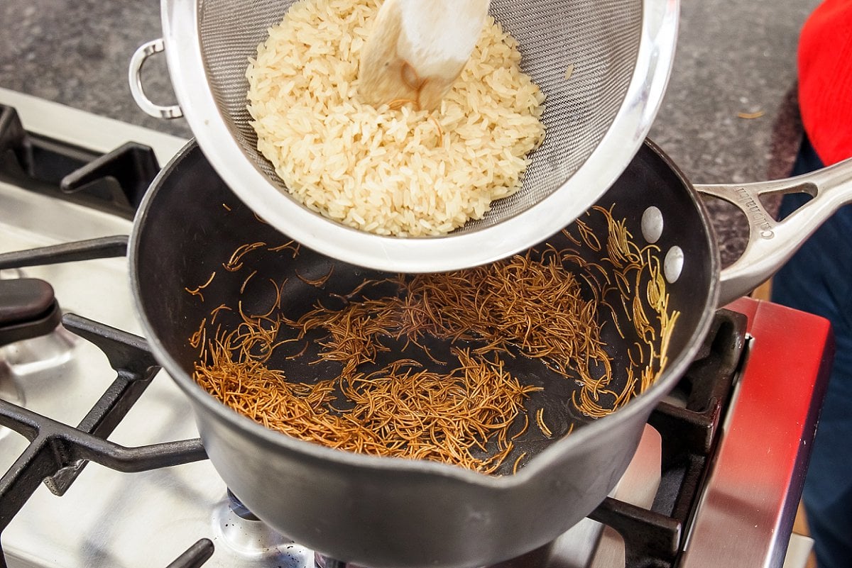 a pot with rice being added to it