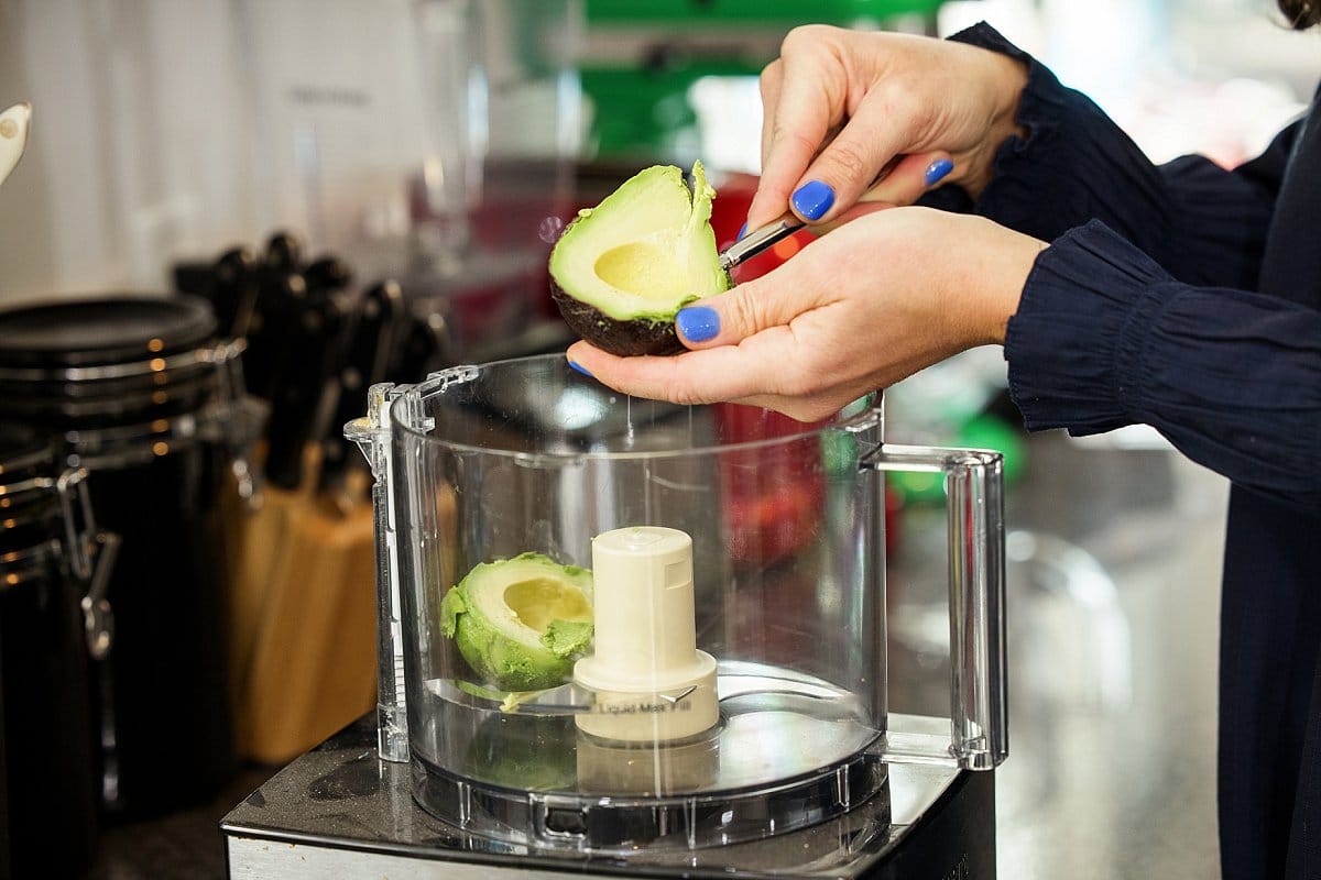 Scooping Avocado into a food processor