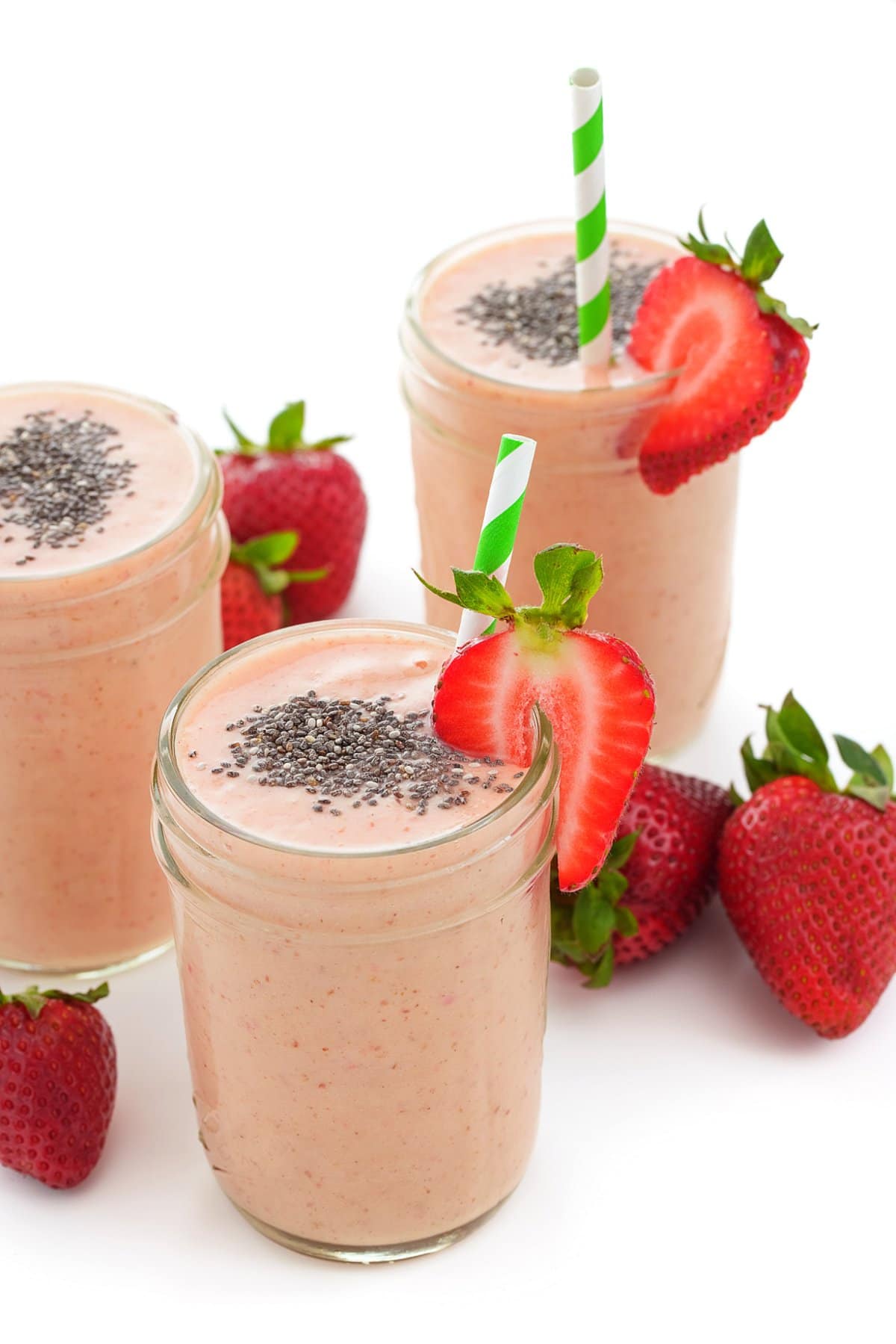 Strawberry Mango Chia smoothie in a glass with strawberries