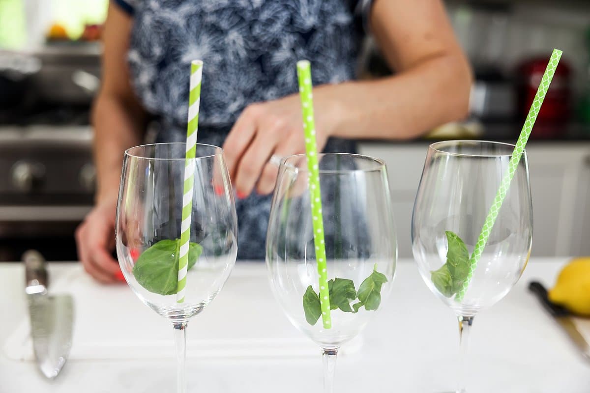 Glasses of lemon basil white wine spritzer with basil