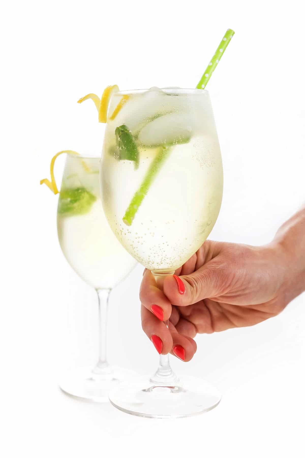 Holding a wine glass with with a spritzer inside