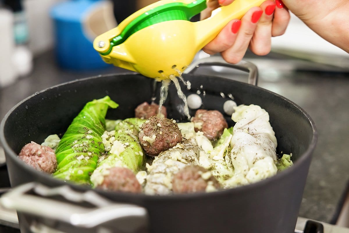 lemon juice being added to a pot