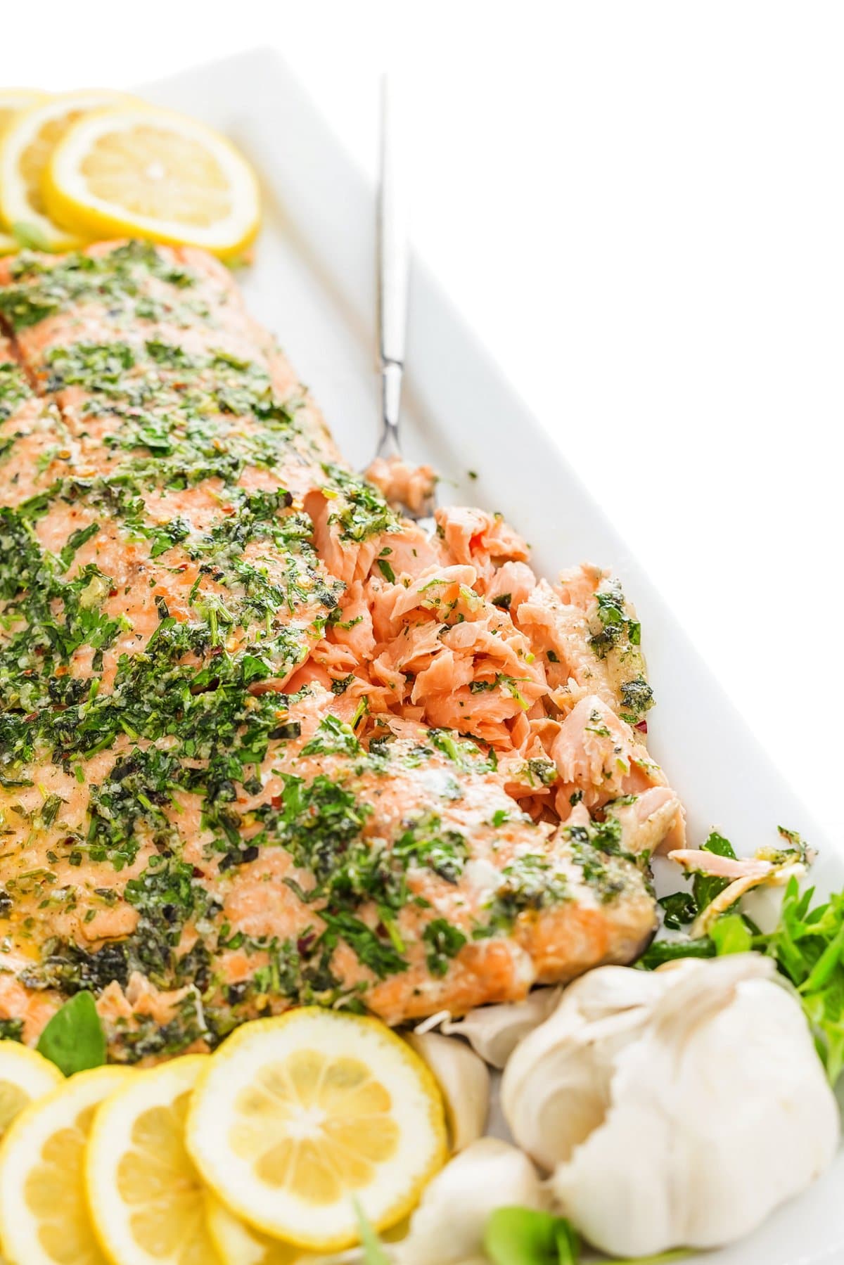 Close up of baked salmon with fresh herbs