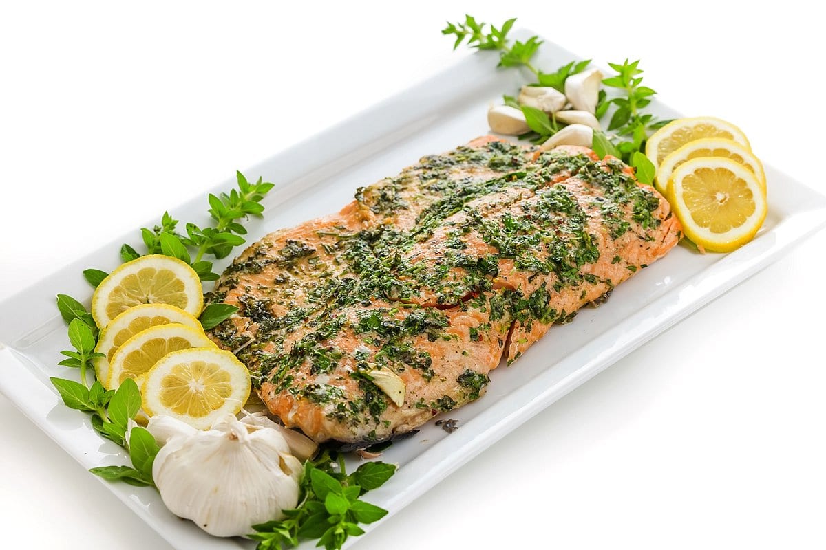 View of baked salmon with fresh herbs