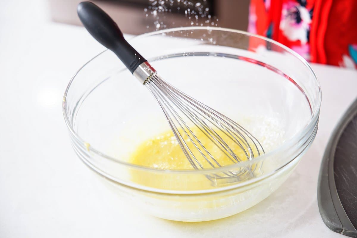 adding seasoning to a bowl