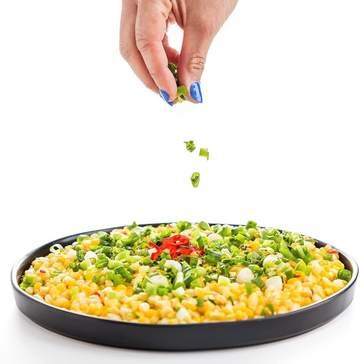 corn skillet having garnish sprinkled onto