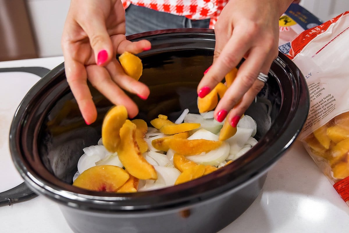 Liz adding peaches to slow cooker