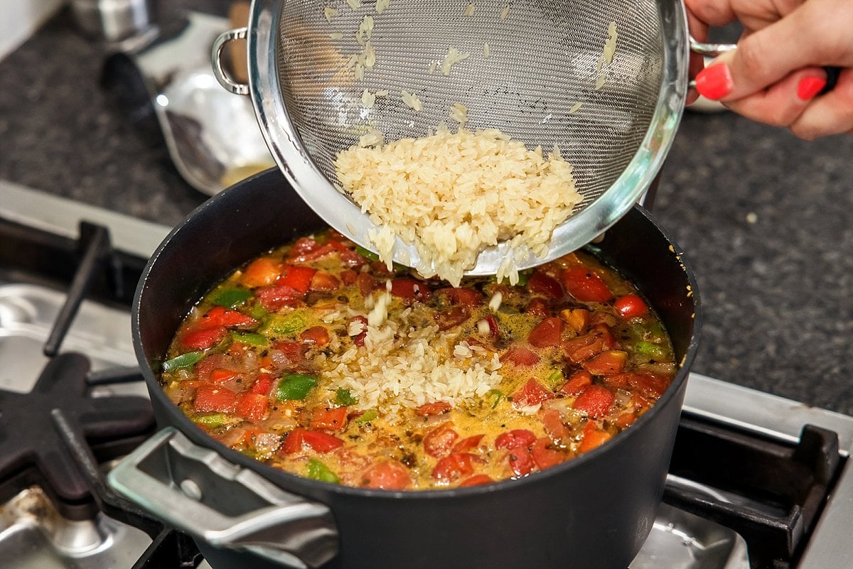 adding rice for stuffed pepper soup