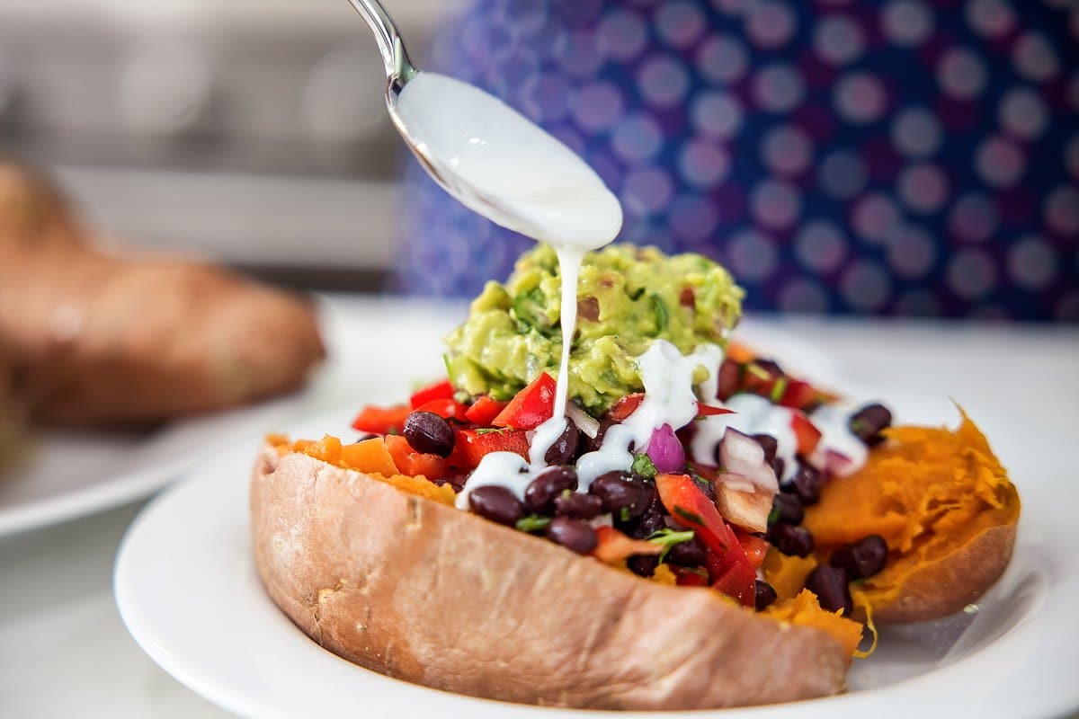 garnishing black bean stuffed sweet potato