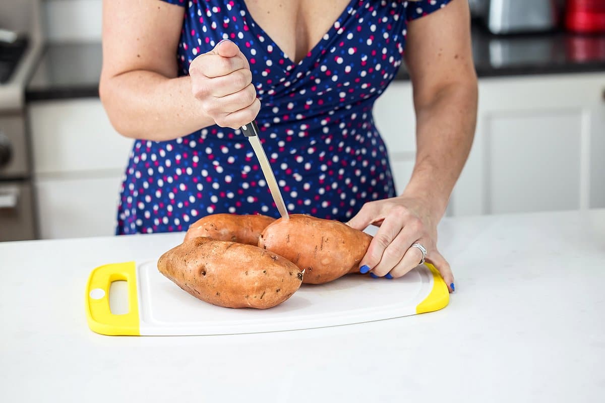 piercing sweet potato with knife