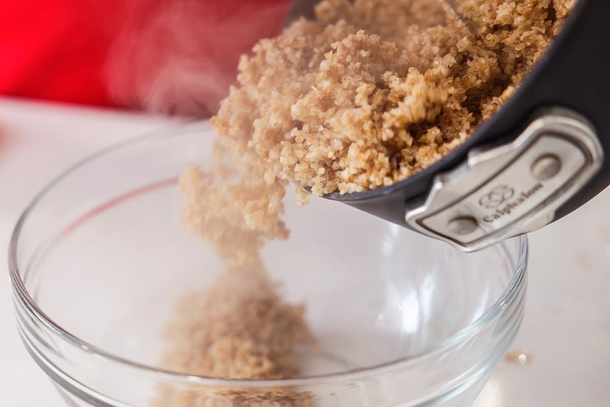 Pouring cooked bulgur wheat in a bowl