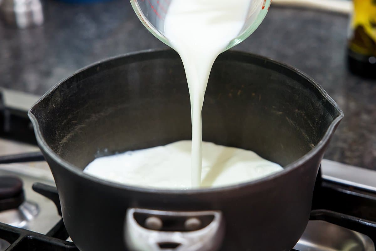 Pouring milk into pot