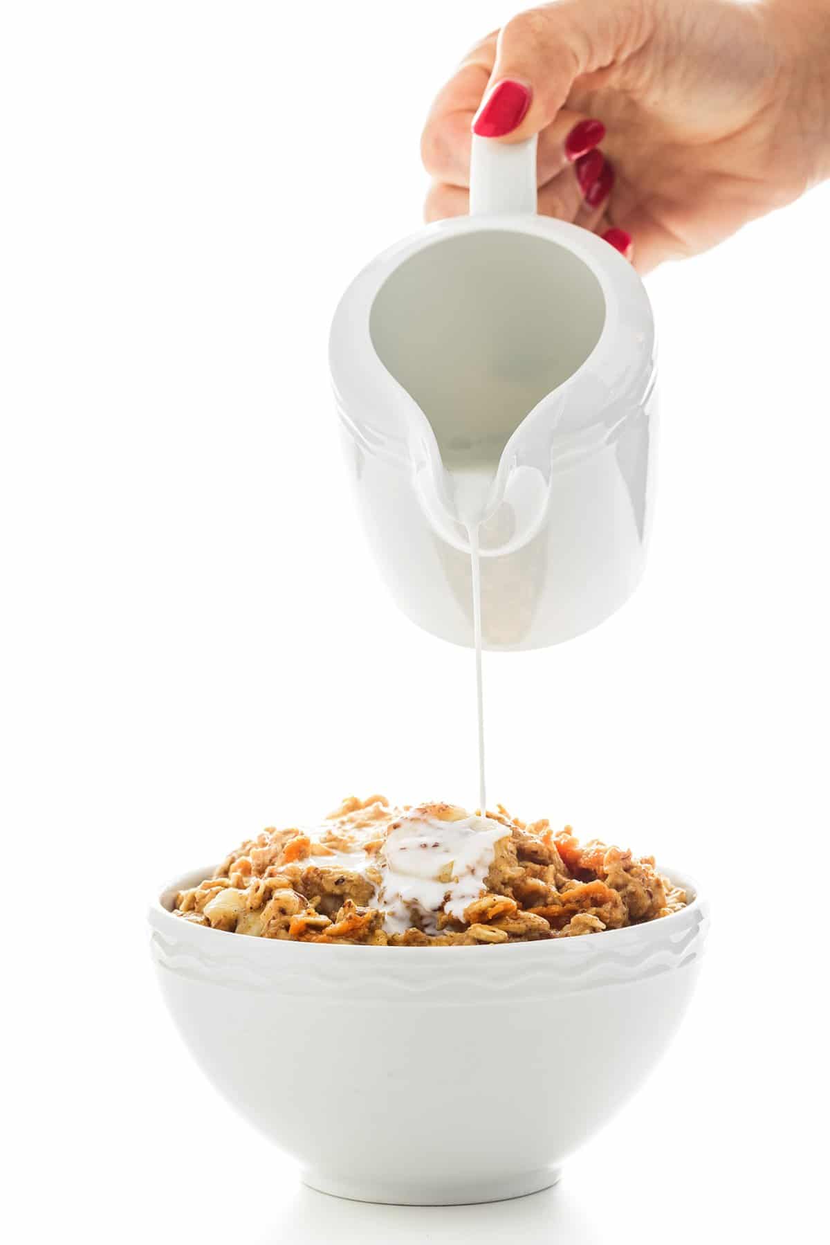 Pouring milk over pumpkin banana oatmeal.