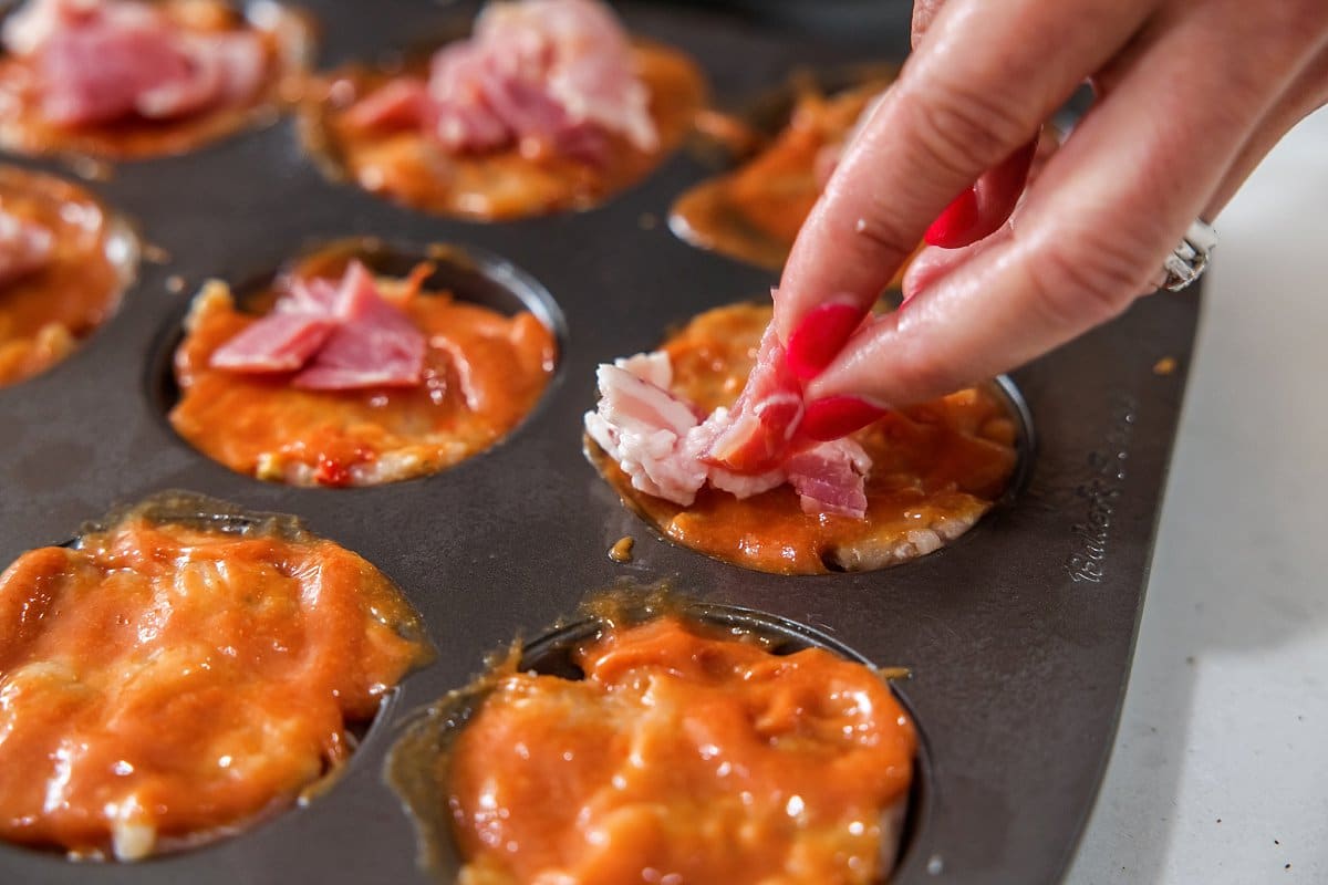 Adding bacon to turkey meatloaf muffins.