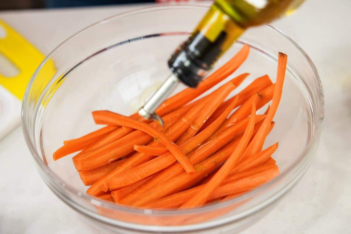 Putting oil on carrots