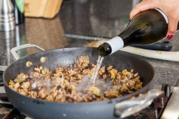 Adding wine to pan