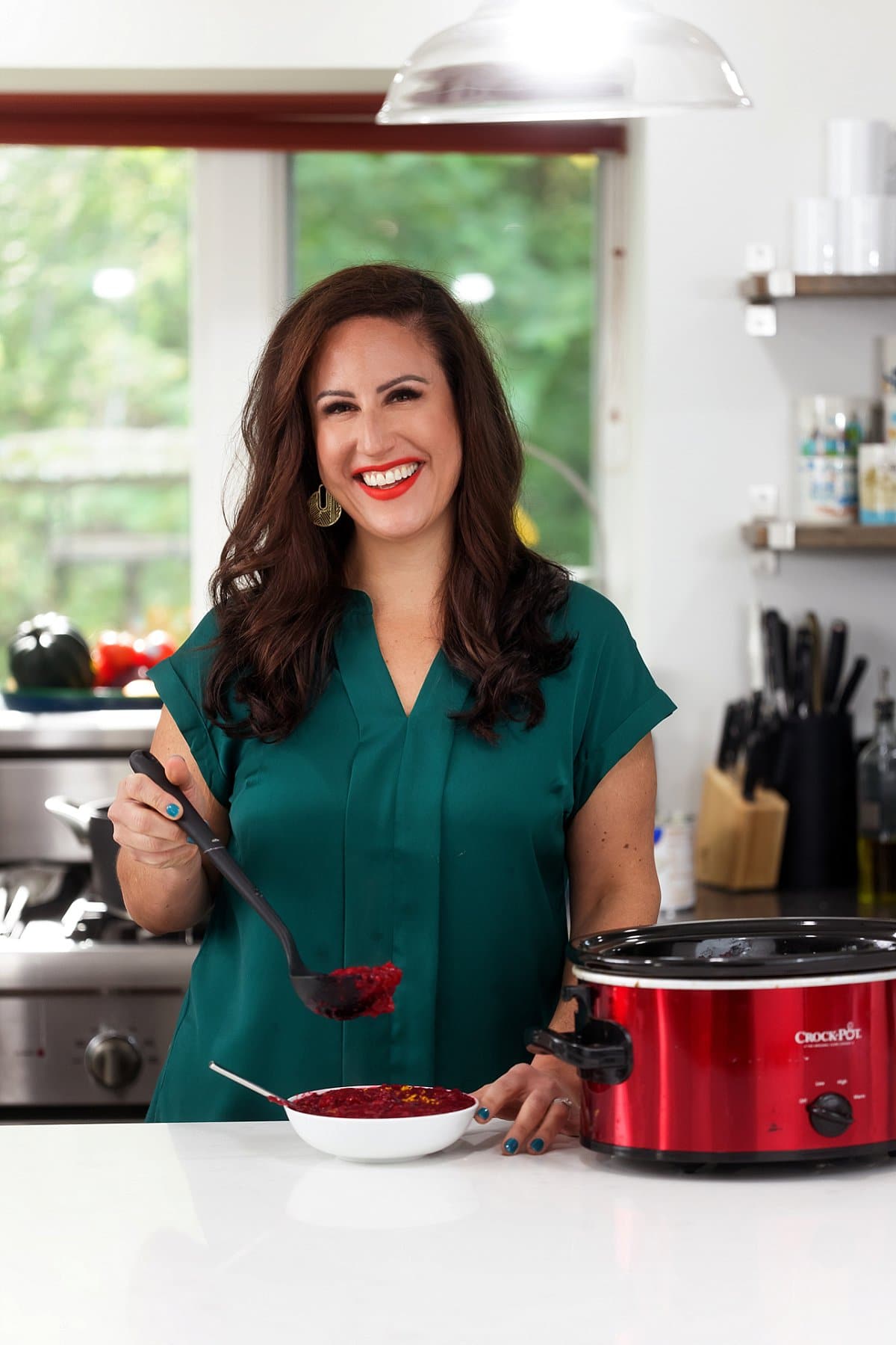 Liz serving slow cooker cranberry sauce.