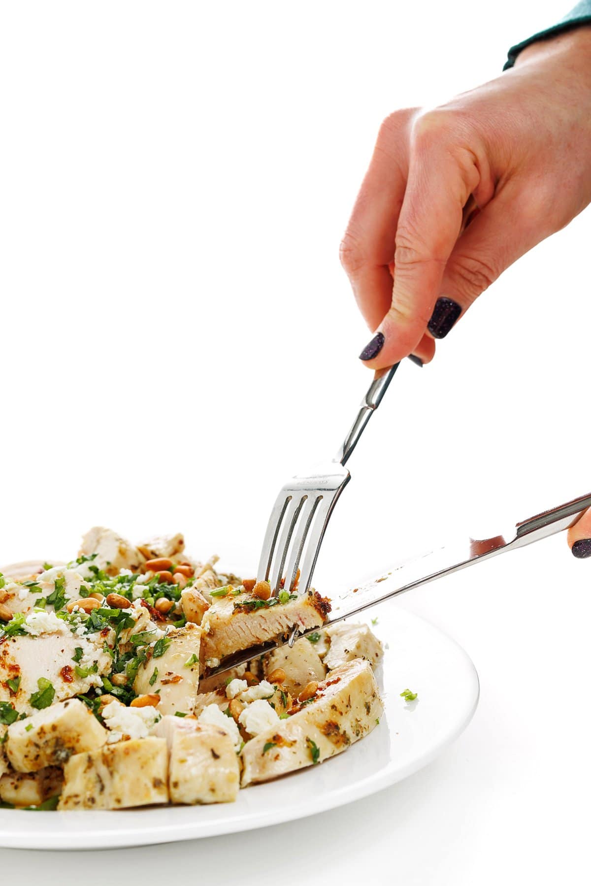 Slicing Greek style baked chicken breasts.