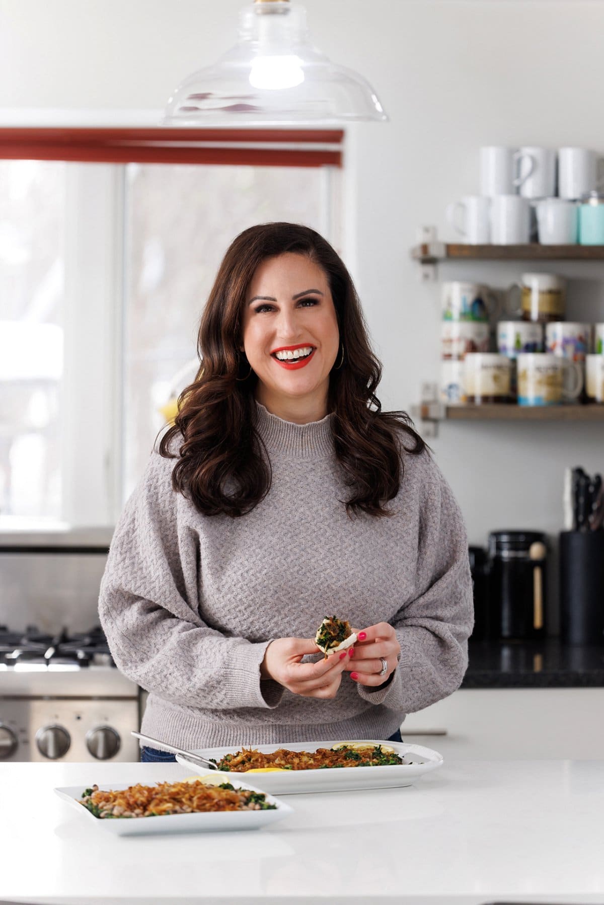 Liz eating garlicky greens with caramelized onions.
