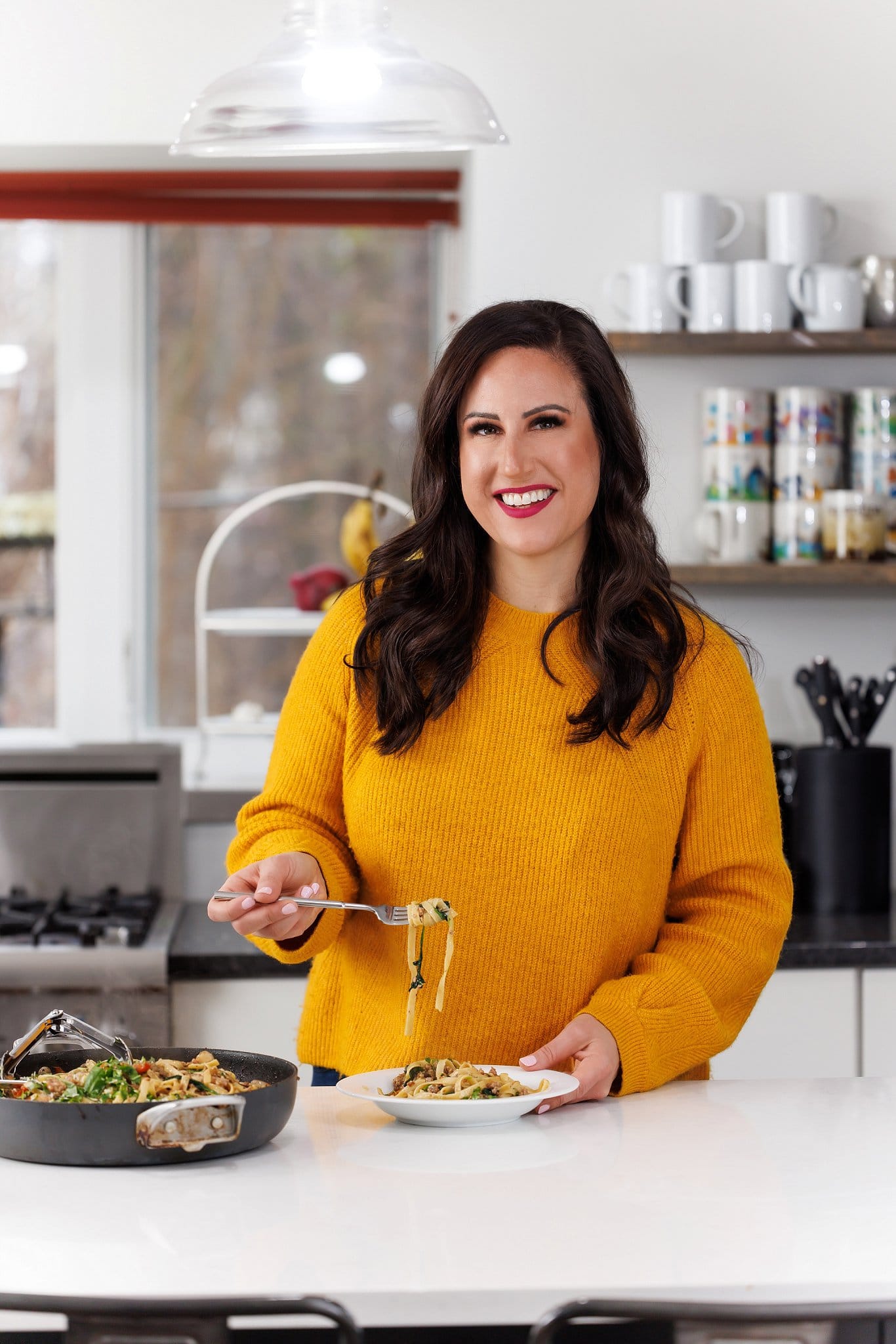 Liz eating one-pan italian sausage pasta.