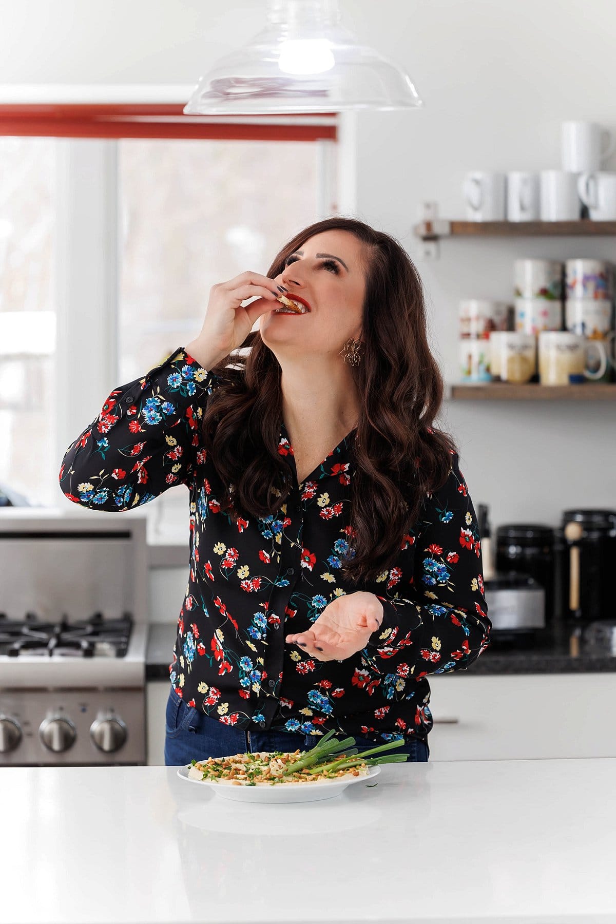Liz eating classic hummus with toasted pine nuts.