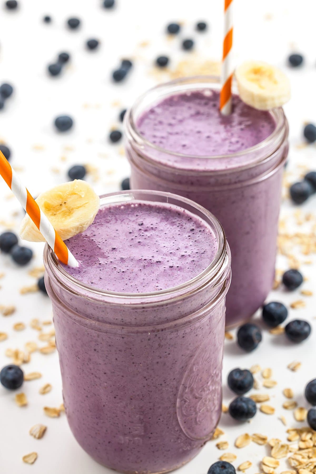 Blueberry banana oatmeal smoothies in mason jar glasses.
