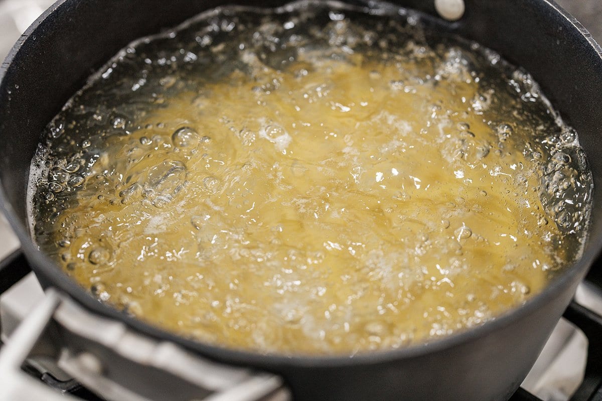 Boiling pasta in water in a large pot.