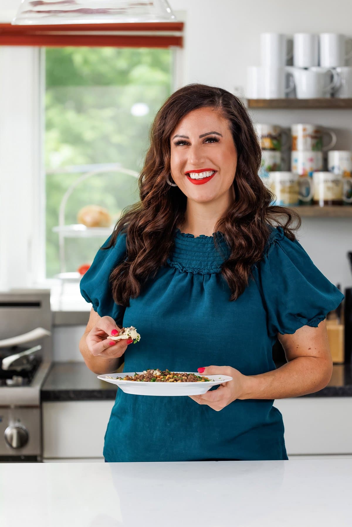 Liz eating hummus with ground beef.