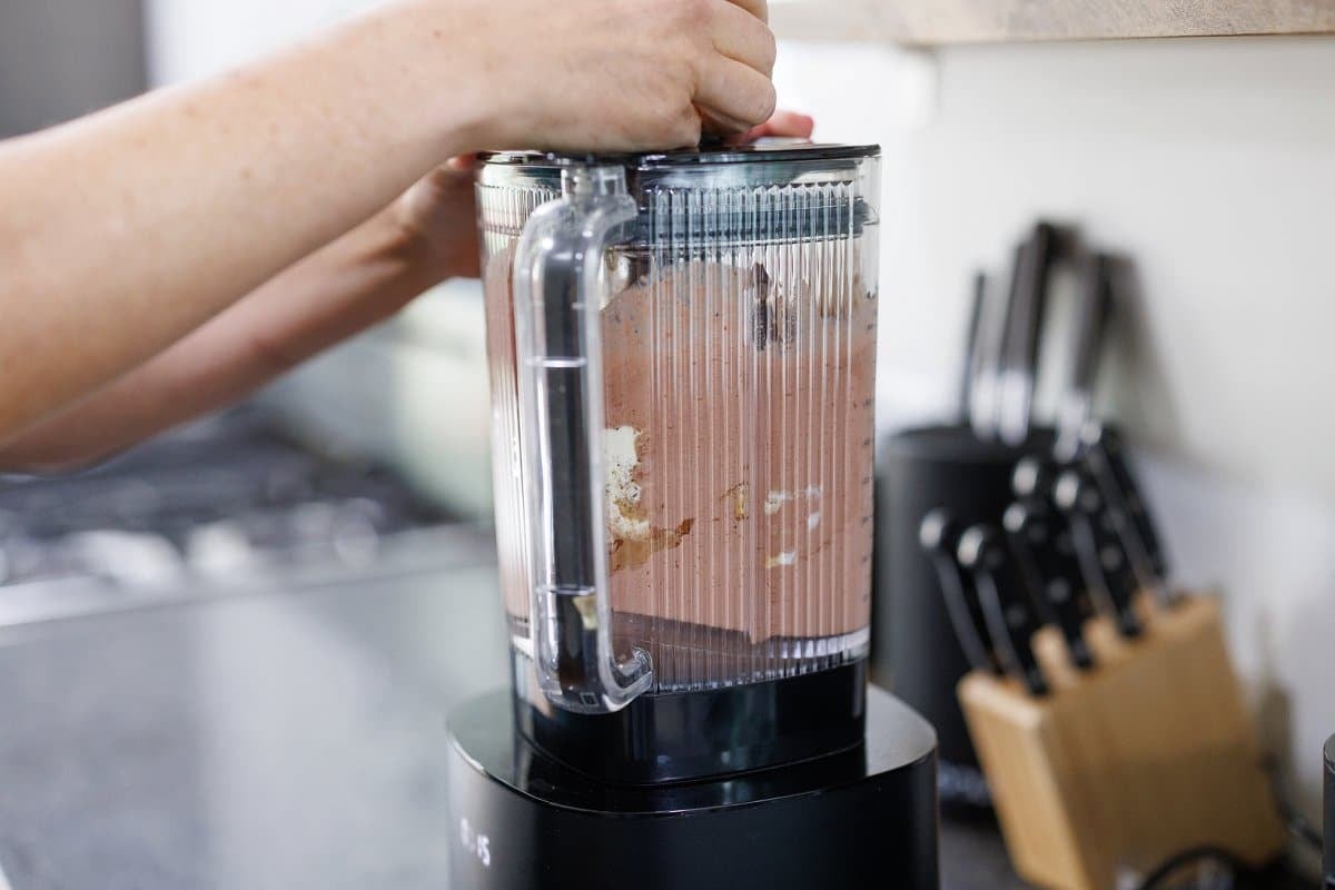 Blending a chocolate strawberry protein smoothie.
