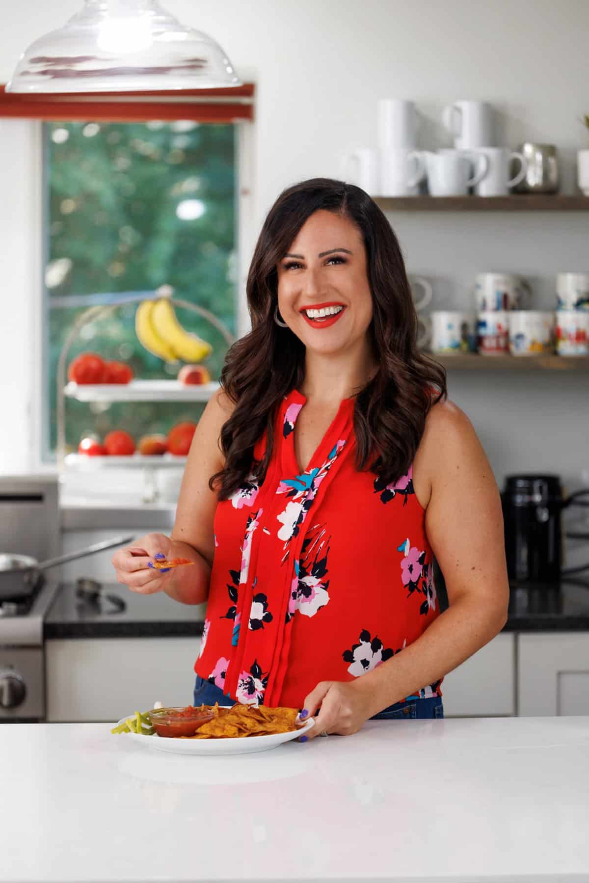 Liz eating baked corn tortilla chips.