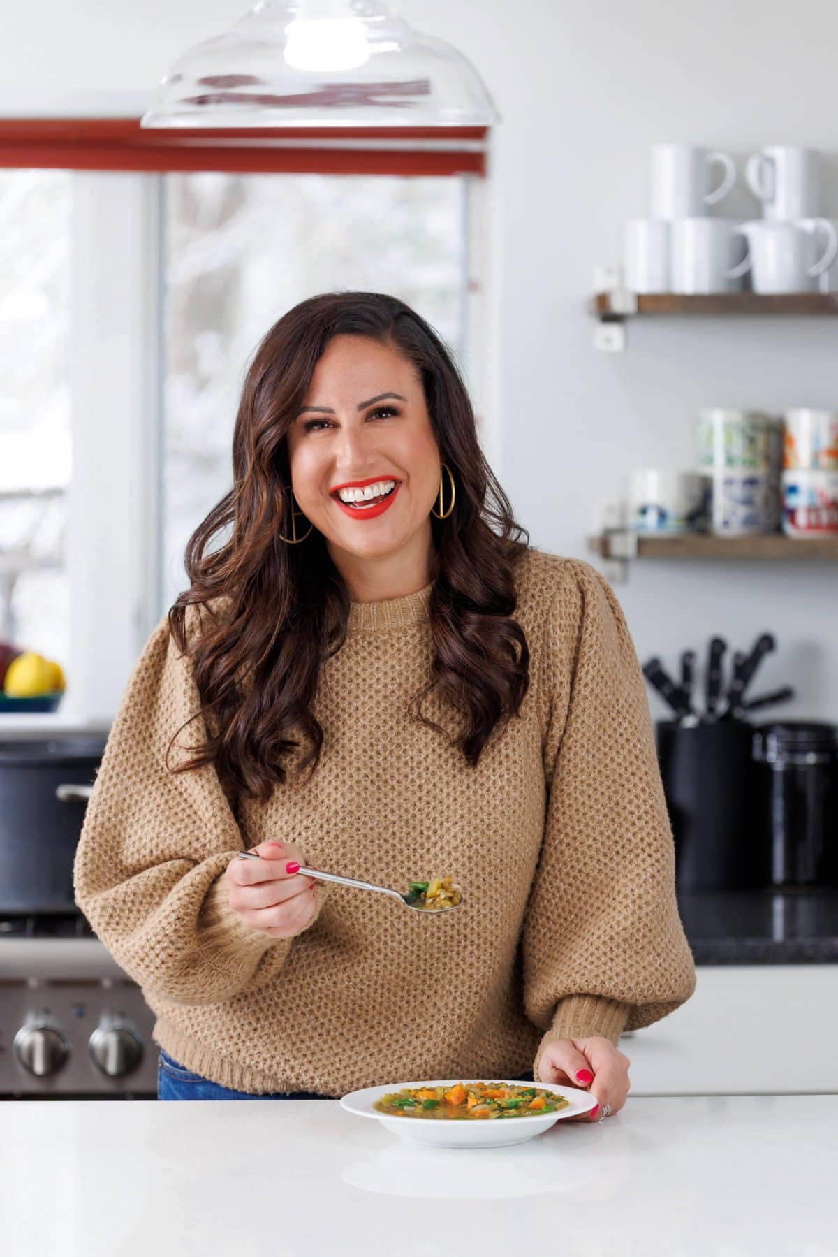 Liz enjoying lemony lentil soup with spinach.