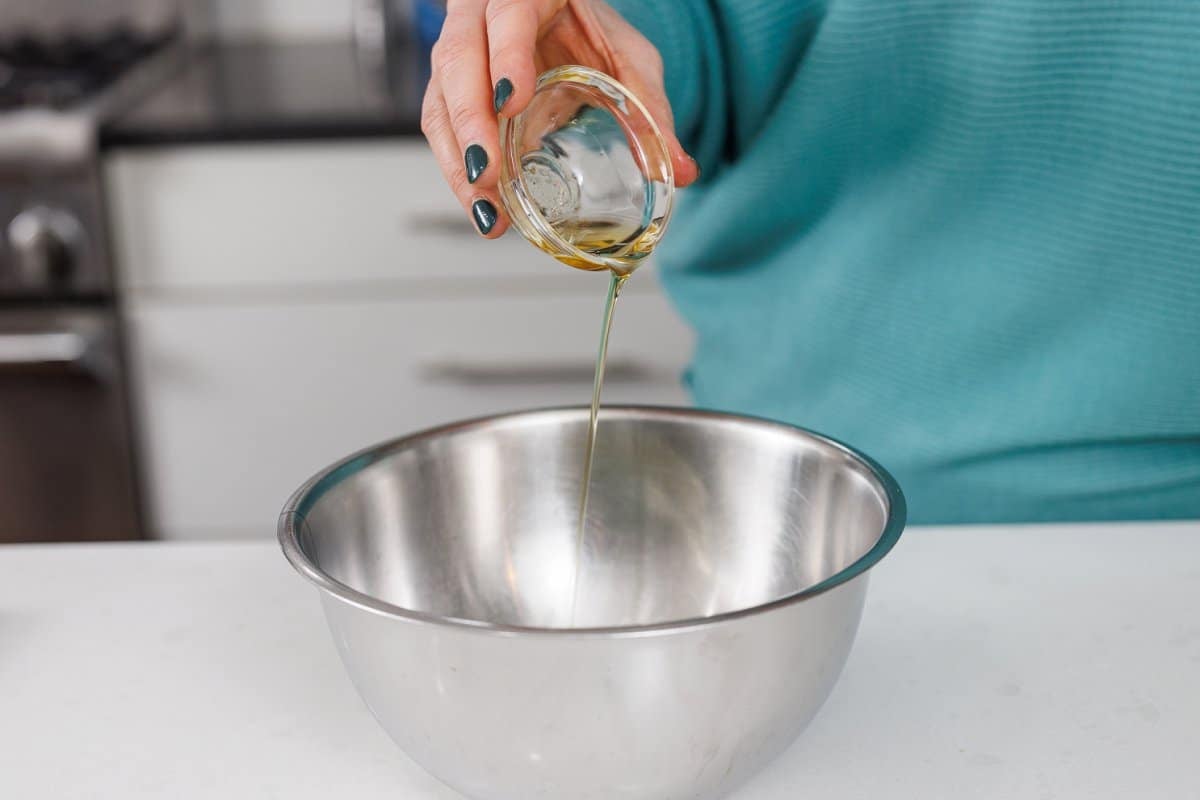 Adding chicken schmaltz to bowl.