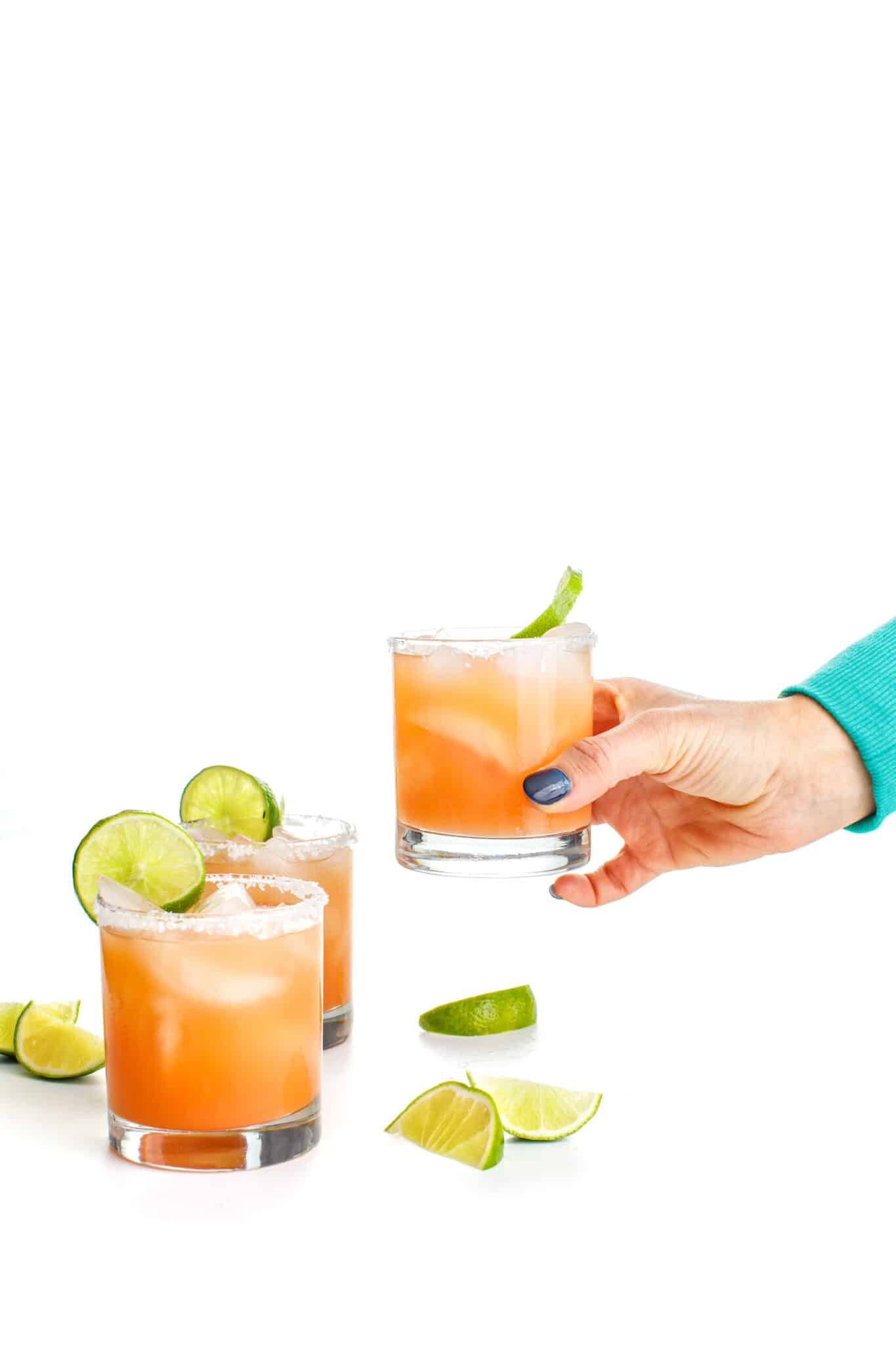 Holding a salty dog cocktail.