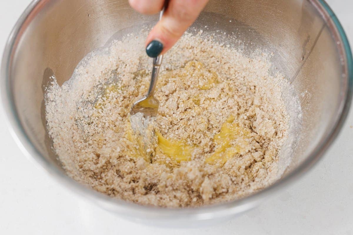 Stirring matzo ball mix with egg.